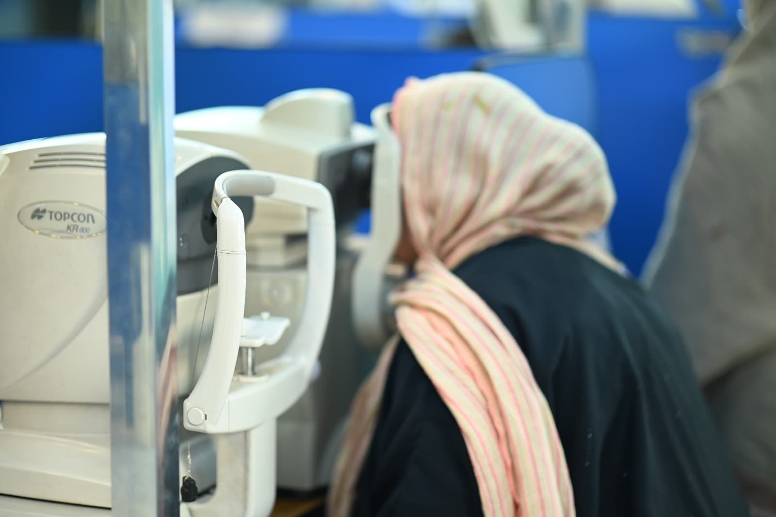 Patient using a Topcon auto kerato-refractometer